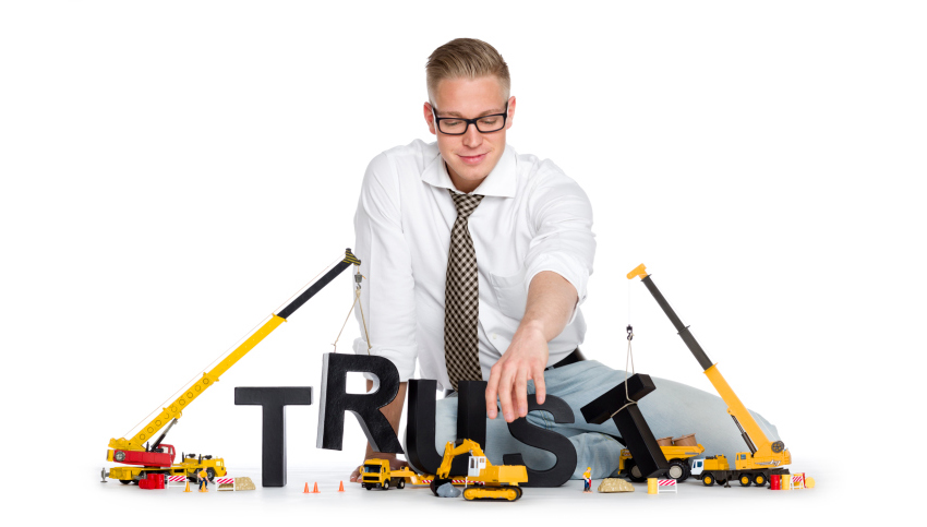 Build up trust: Businessman building trust-word.