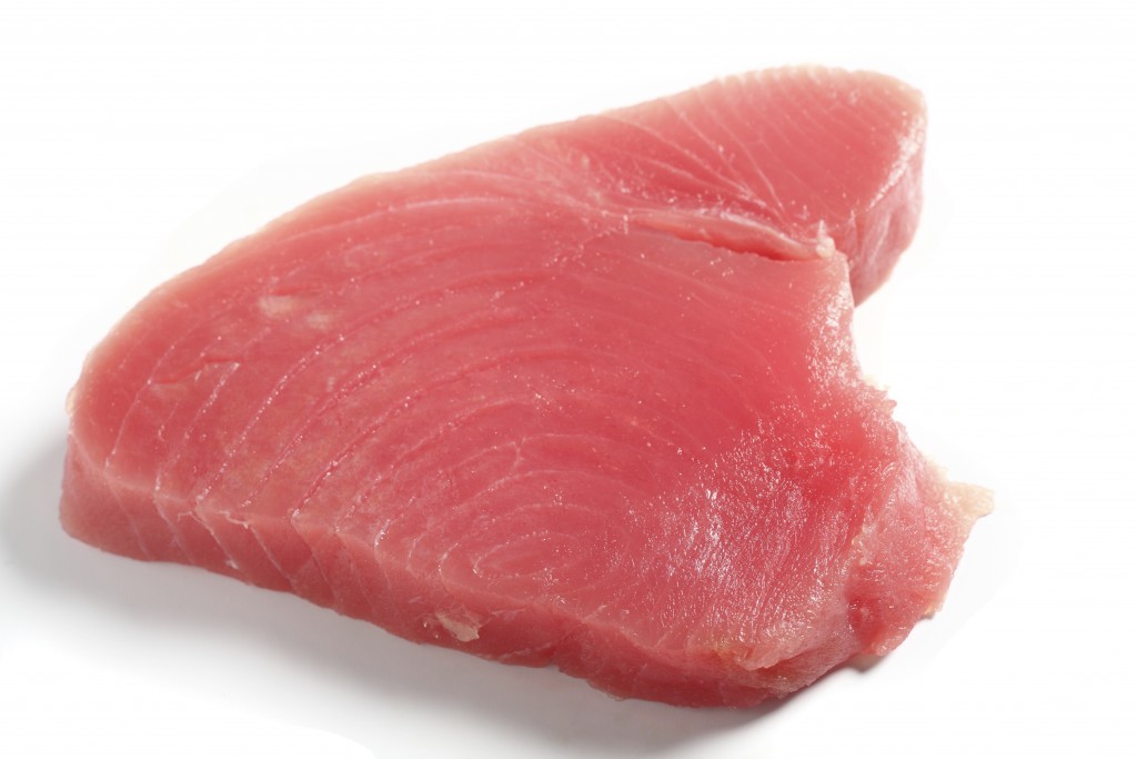 Bluefin tuna (blue ahi tuna) steak, over white. This is regarded as the finest tuna and is the kind used in sushi.
