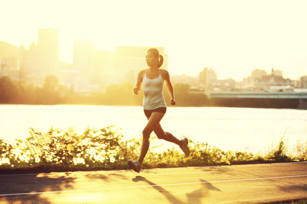 Female runner running at sunset