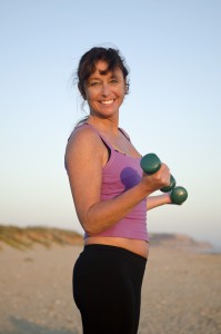 woman exercising on the beach.