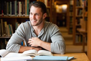 Smiling male student working